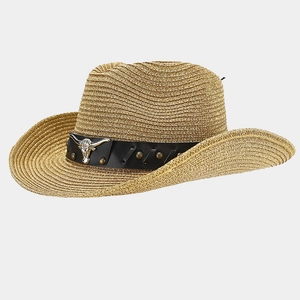 Detail of straw cowboy hat featuring metal bull head relief and vintage rivets on black band