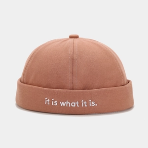 Detail of cotton docker hat featuring white embroidered slogan it is what it is text
