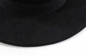 Detailed macro view of the black wool felt fedora brim and textured grosgrain ribbon band
