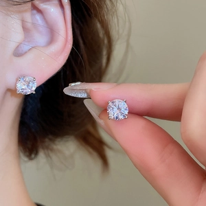 Detailed view of shimmering cubic zirconia round stud earrings with classic four-prong setting
