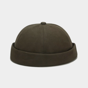 Detail view of cotton twill docker hat in olive green with classic rolled edge and top button