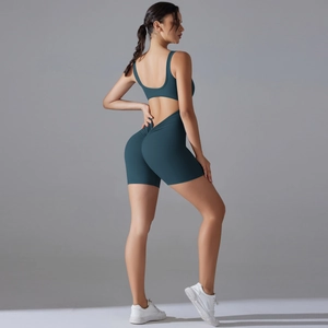 Macro detail of teal backless yoga bodysuit with scrunch butt and cutout waist design