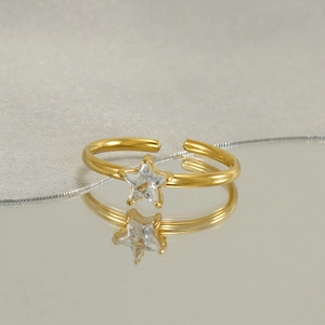 Detailed view of an adjustable gold star ring featuring a shimmering zircon center stone