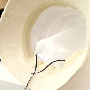 Detailed view of beige sun hat interior with adjustable drawstring and inner sweatband