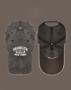 Detail of washed cotton baseball cap with white Brooklyn 3D embroidery and vintage distressed edge