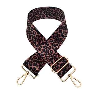 Detail of adjustable leopard print bag strap with polished light gold metal hardware