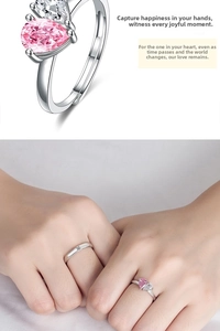 Detailed close-up showing pink and white pear-shaped zircon stones on silver lovers' rings