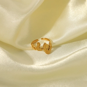 Close-up of irregular hammered texture on gold stainless steel adjustable ring