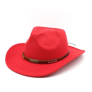 Detail of red wool felt cowboy hat with a brown belt strap and vintage metal buckle