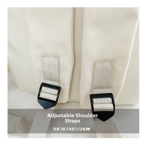 Detail view of adjustable black plastic buckles and durable canvas shoulder straps
