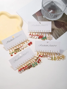 Detailed view of Christmas earring set with Santa, snowflake, and reindeer oil drip charms