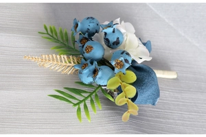 Detail of Morandi blue berries and white silk flower groom boutonniere for weddings