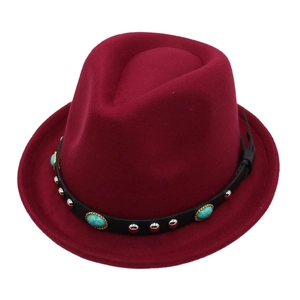Detailed shot of turquoise studs and silver rivets on a burgundy wool felt fedora band
