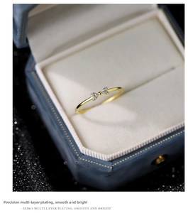 Macro detail of a bow-shaped ring with pavé cubic zirconia in a velvet box