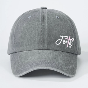 Close-up of vintage washed gray cotton baseball cap with Faith embroidery and pink cross