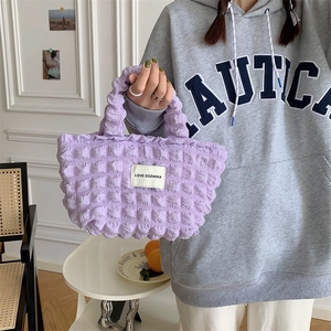 Detail of purple bubble textured tote bag with LOVE SOZAKKA label and zipper closure