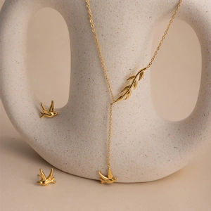 Elegant 18K gold plated stainless steel jewelry set with bird pendants and leaf details
