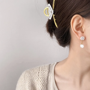 Elegant Hepburn-style double pearl drop earrings with gold metal link on a female model