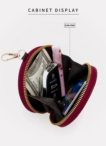 Detailed interior of a round burgundy leather coin purse showing storage for cards and keys