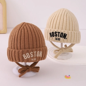 Close-up of Boston embroidery and ribbed knit texture on warm winter baby hats