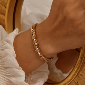 Detail of vintage 18K gold plated chain bracelet with sparkling zircon stones on a wrist