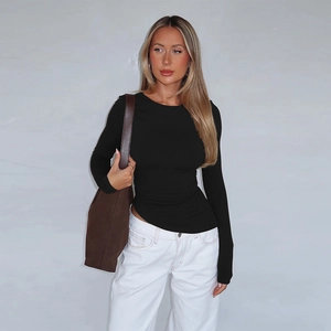 Detail of black long sleeve slim fit T-shirt with asymmetrical hem and clean tailoring