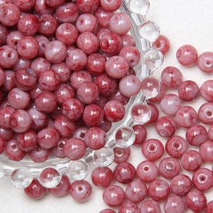 Macro detail of 8mm deep red glass beads with mesh texture for DIY jewelry making