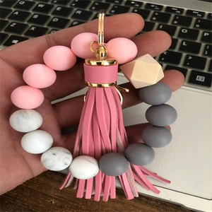Silicone bead keychain wristlet with pink tassel and geometric wood bead detail
