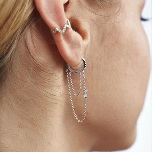 Detail of silver S925 chain tassel earrings and ear cuff set with pavé cubic zirconia