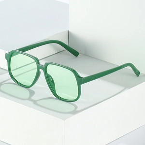 Square Morandi green sunglasses on geometric blocks for a minimalist fashion look