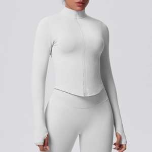 Detail view of the thumb hole cuffs and ribbed knit fabric on white yoga jacket