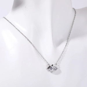 Dettaglio di una collana in argento con ciondolo in zircone indossata da una modella