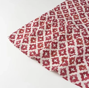 Close-up of lightweight red geometric floral print fabric with soft texture details