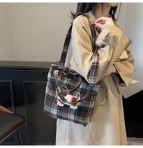 Detail of wool plaid tote bag featuring a cute 3D cartoon puppy embroidery patch