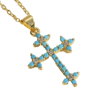Gold cross necklace with light blue beads and white crystals on a white background