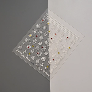 Detailed macro view of 5D embossed Christmas nail stickers with white snowflakes and gems