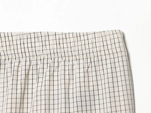 Macro view of elastic waistband and black and white checkered fabric on fashion pants