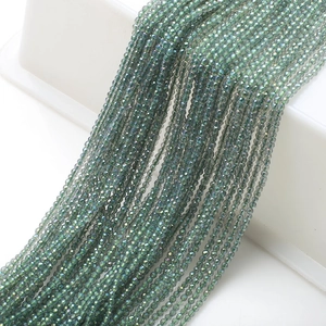 Macro shot of 2mm dark green faceted glass beads on strings for DIY jewelry making