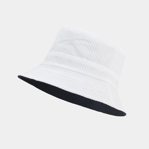 Close-up of the corduroy texture and two-tone design on a white and black bucket hat