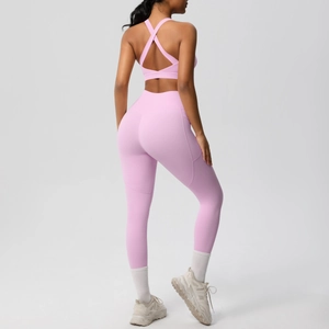 Rear view of pink double-sided brushed yoga set showing cross-back bra and high-waist leggings