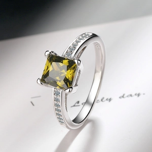 Close-up of S925 sterling silver ring featuring a square-cut green gemstone and side diamonds