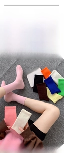 Detailed flat lay of colorful ribbed crew socks in multiple vibrant cotton shades