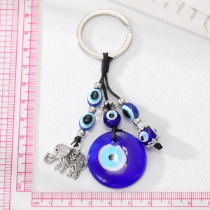 Vintage elephant evil eye keychain with blue glass bead and silver alloy pendant detail