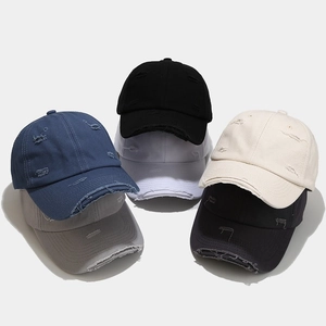 Distressed cotton baseball caps in multiple colors with vintage frayed hole details