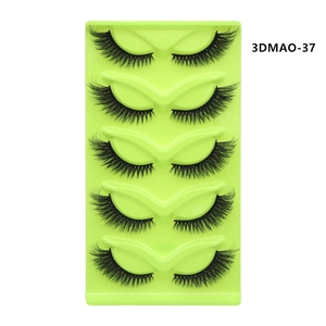 Detail view of 5 pairs of dense 3D cat-eye faux mink lashes on a green tray