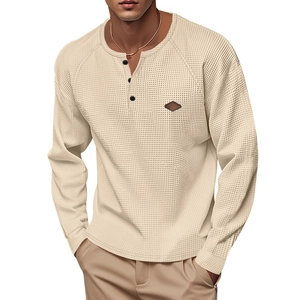 Detail of waffle knit fabric and three-button placket on beige men's long sleeve henley