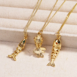 Close-up of golden koi fish pendants with fine scales and colorful enamel accents