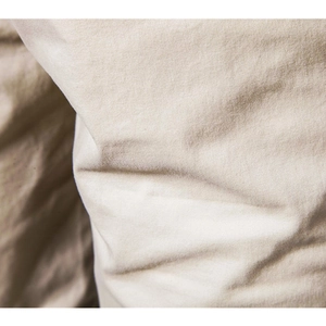 Macro shot of khaki cotton twill fabric texture and durable stitching detail