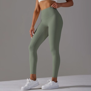 Detailed view of high-waisted seamless sage green yoga pants with matte elastic fabric