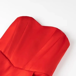 Detailed macro shot of red satin strapless dress with pleated heart-shaped neckline